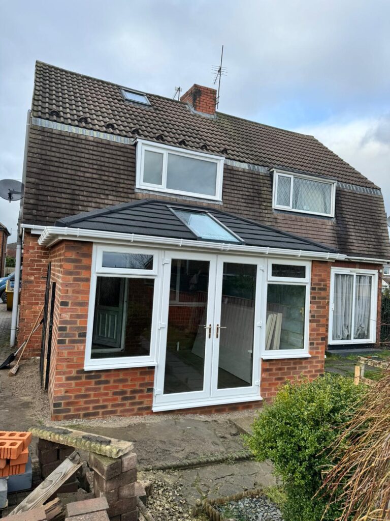 a double-hipped Edwardian Supalite roof, and a blue glass vista